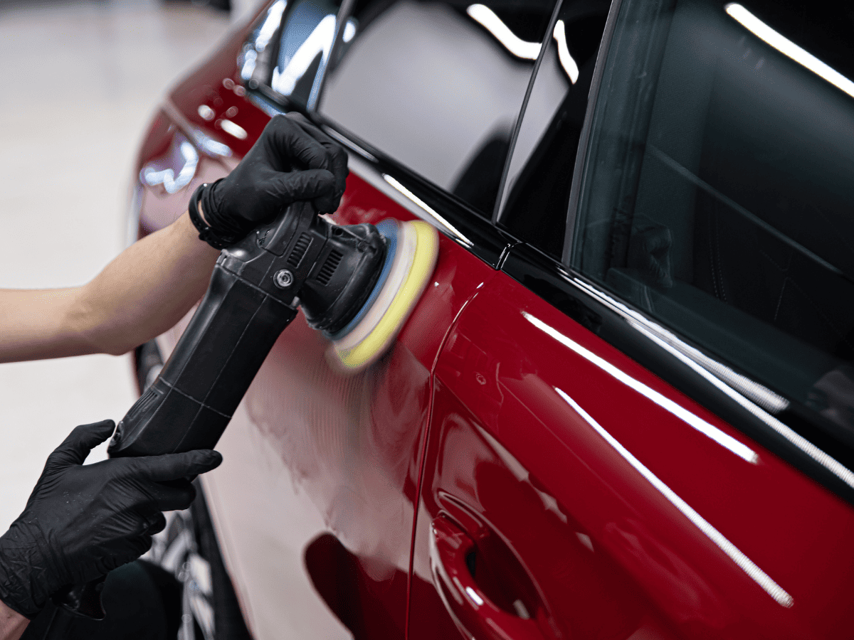 Machine polishing a car panel during paint correction